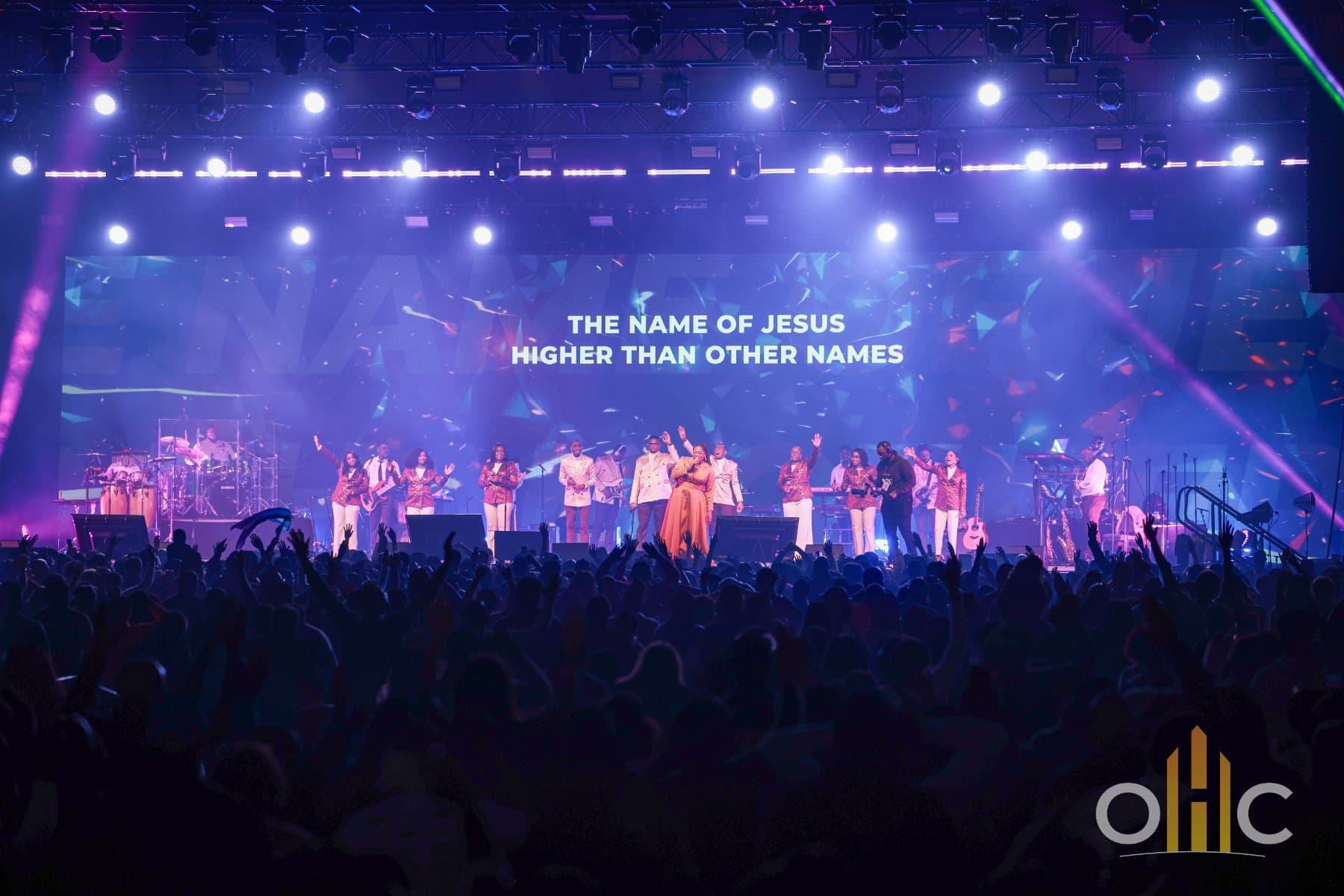 NCA Psalmists leading worship on stage at Open Heavens Calgary 2024 as the crowd raises their hands
